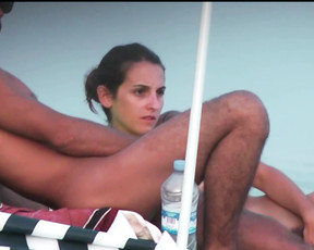 Brunette babe is getting excited on the beach in family nudist camp