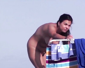 Playful naturist babes caught on a hidden camera enjoying a hot summer day at the beach