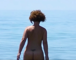 Playful nudist cuties have fun at the beach