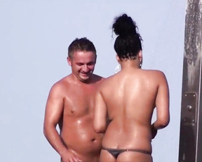 Voyeur sets up a hidden camera to film nudist babes taking an outdoor shower at the beach