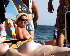 Nudist girl with small tits is hanging out with her friends at the beach