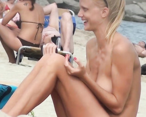 Blonde women with their tits out at a naked beach
